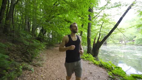 Happy-young-man-running-in-the-forest.